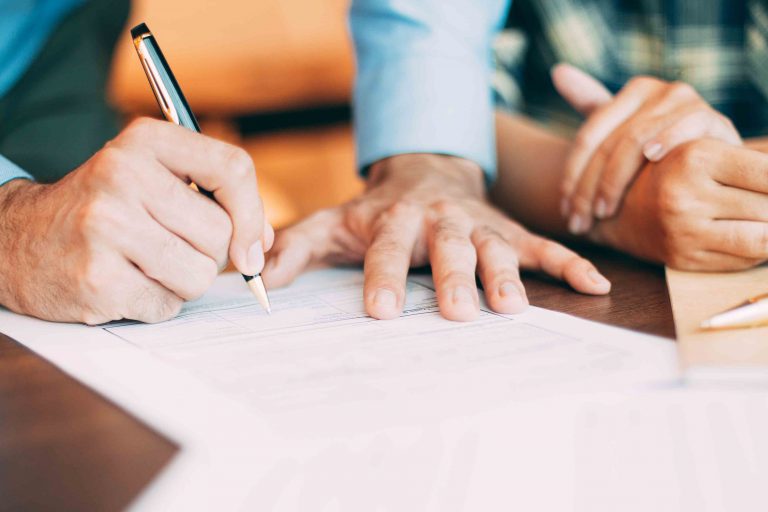 Senior candidate filling application form at table